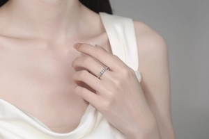Detail of silver five-star zircon ring on model finger showing elegant star embossing