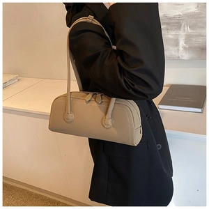 Detail view of khaki leather tote bag with double metal zippers and long thin shoulder straps