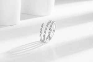 Macro shot of silver triple-layer spiral ring with micro-paved cubic zirconia stones