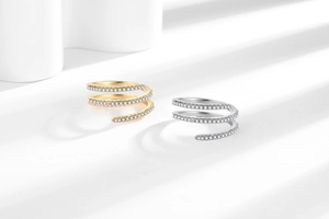 Macro shot of spiral pavé set rings in gold and silver finish with white crystals