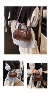 Close-up of dark brown glossy patent leather handbag with elegant bow details and handles