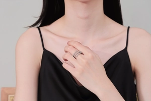 Close-up of a silver spiral spring ring with pave diamonds worn on a woman's index finger