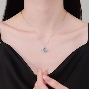 Silver planet and star necklace with sparkling moissanite pendant on a female neck