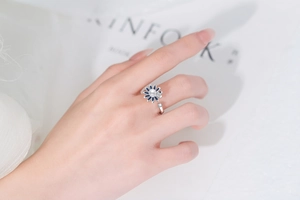 Detail of sunflower spinner ring featuring a white pearl center and crystal petals