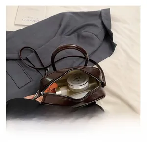 Detailed interior view of a dark brown vintage bowling bag showing makeup storage space