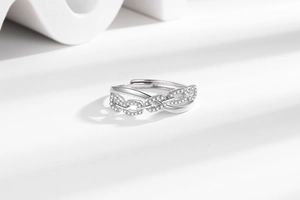 Detail of silver chain link ring with sparkling zircon stones and a polished finish