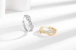 Detailed view of gold and silver chain link earrings with micro-set zircon stones