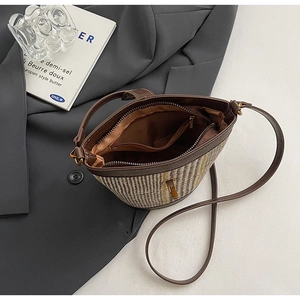 Top view of bucket bag interior featuring brown lining, zipper pocket and woven texture