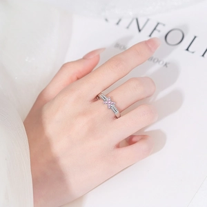 Pink butterfly cross ring in silver finish with white crystals worn on finger