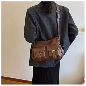 Brown vintage faux leather tote bag styled with gray blazer and black skirt