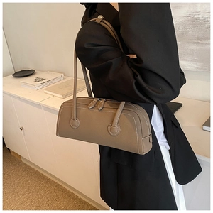 Close-up of minimalist tote bag showing white contrast stitching and premium grey texture