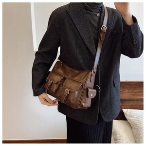 Detail of dark brown vintage faux leather tote bag with functional double front pockets