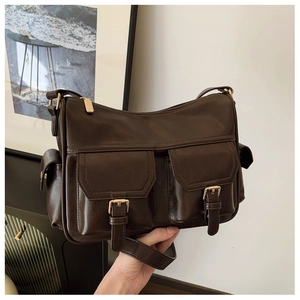 Detail of dark brown vintage faux leather tote bag with double front magnetic pockets