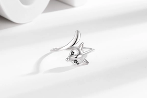 Macro detail of adjustable fox ring in silver metal with black gemstone eyes