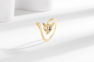 Close-up of a golden fox open ring with black gem eyes and detailed metallic tail band