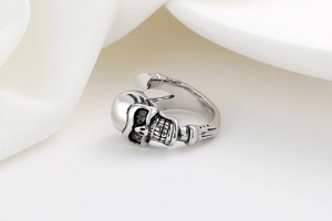Detailed close-up of retro silver skull ring with gothic bone texture and oxidized finish