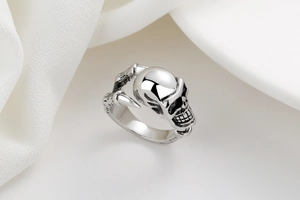 Close-up of vintage skull ring with gothic claw details and polished silver finish