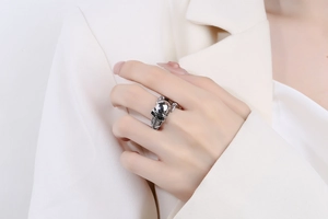 Detail of gothic silver skull ring with claw design on hand for punk style