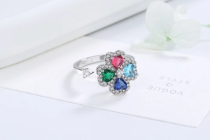 Detailed macro view of rotating four-leaf clover ring with multi-color heart-shaped zircons