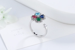 Macro shot of colorful four-leaf clover zircon rotating ring with adjustable silver band