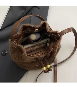 Spacious interior of brown faux fur bucket bag with phone and cosmetics layout
