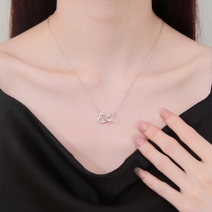 Elegant silver interlocking double heart pendant necklace on a delicate chain for women
