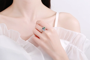 Close-up of rotatable clover ring with colorful heart crystals and diamond accents