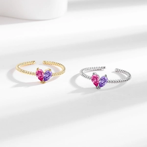 Minimalist twisted rope rings featuring heart-shaped pink and purple zircons in gold and silver