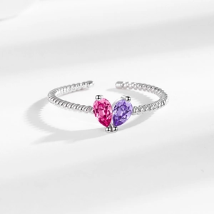 Adjustable silver ring with pear-cut pink and purple stones on a twisted rope band