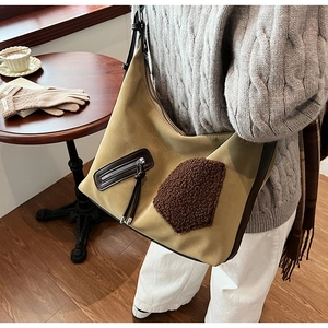 Detail of winter crossbody bag with khaki matte texture and brown plush decorative patch