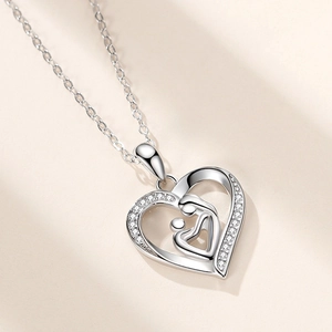 Silver heart-shaped mother and child pendant necklace with sparkling zircon pavé
