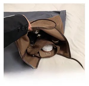 Detailed interior of brown fuzzy tote bag showing large capacity and zipper inner pouch