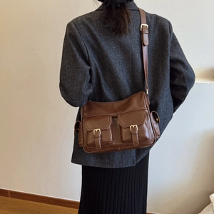 Dark brown faux leather tote bag with dual utility pockets and adjustable strap