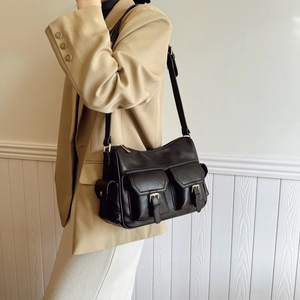 Classic black leather tote bag with gold buckles and front pockets for women