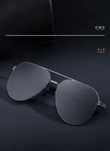 Detail shot of classic aviator sunglasses featuring dark gray metal frame and black polarized lenses