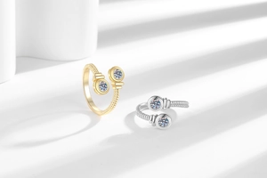 Close-up of twisted adjustable rings with dual round crystals in gold and silver