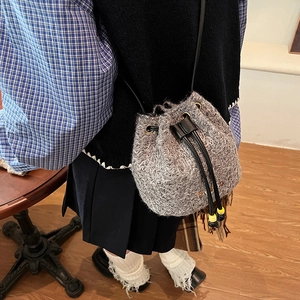 Winter plush drawstring bucket bag with orange M embroidery and leather strap