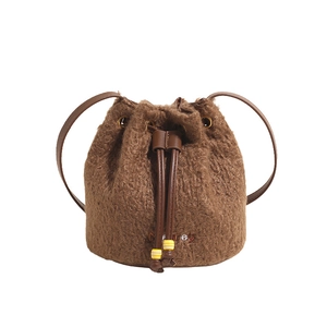 Brown teddy fleece bucket bag with leather drawstring and Monney embroidery detail