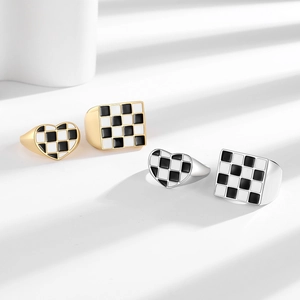 Minimalist checkerboard heart and square rings in gold and silver finish on white background
