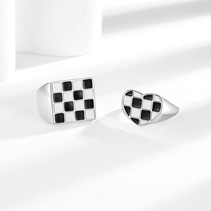 Minimalist checkerboard rings with silver heart and square designs on a white background