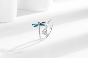 Macro shot of the blue enamel dragonfly wings and silver adjustable ring band detail
