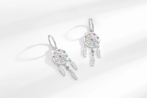 Detail of dreamcatcher hoop earrings with colorful cubic zirconia and metallic feathers