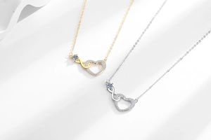 Detail of Infinity Heart necklace set in gold and silver with sparkling diamonds