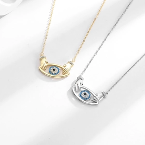 Devil's Eye pendant necklaces with hands design in gold and silver finish for women
