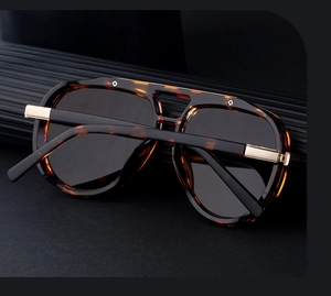 Close-up of tortoise shell frame and gold metal hinges on aviator sunglasses