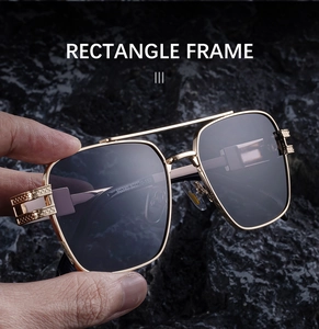 Close-up of rectangle sunglasses with golden metal frame and grid texture detail