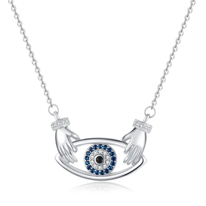 Evil eye necklace with silver hands hugging pendant and sparkling blue zircons