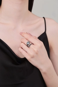 Detail of vintage adjustable ring featuring an opal stone and retro engraved patterns
