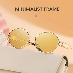 Detailed macro view of vintage gold metal oval sunglasses with minimalist frames