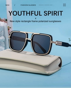 Detail of premium polarized sunglasses featuring a golden double bridge and striped temples